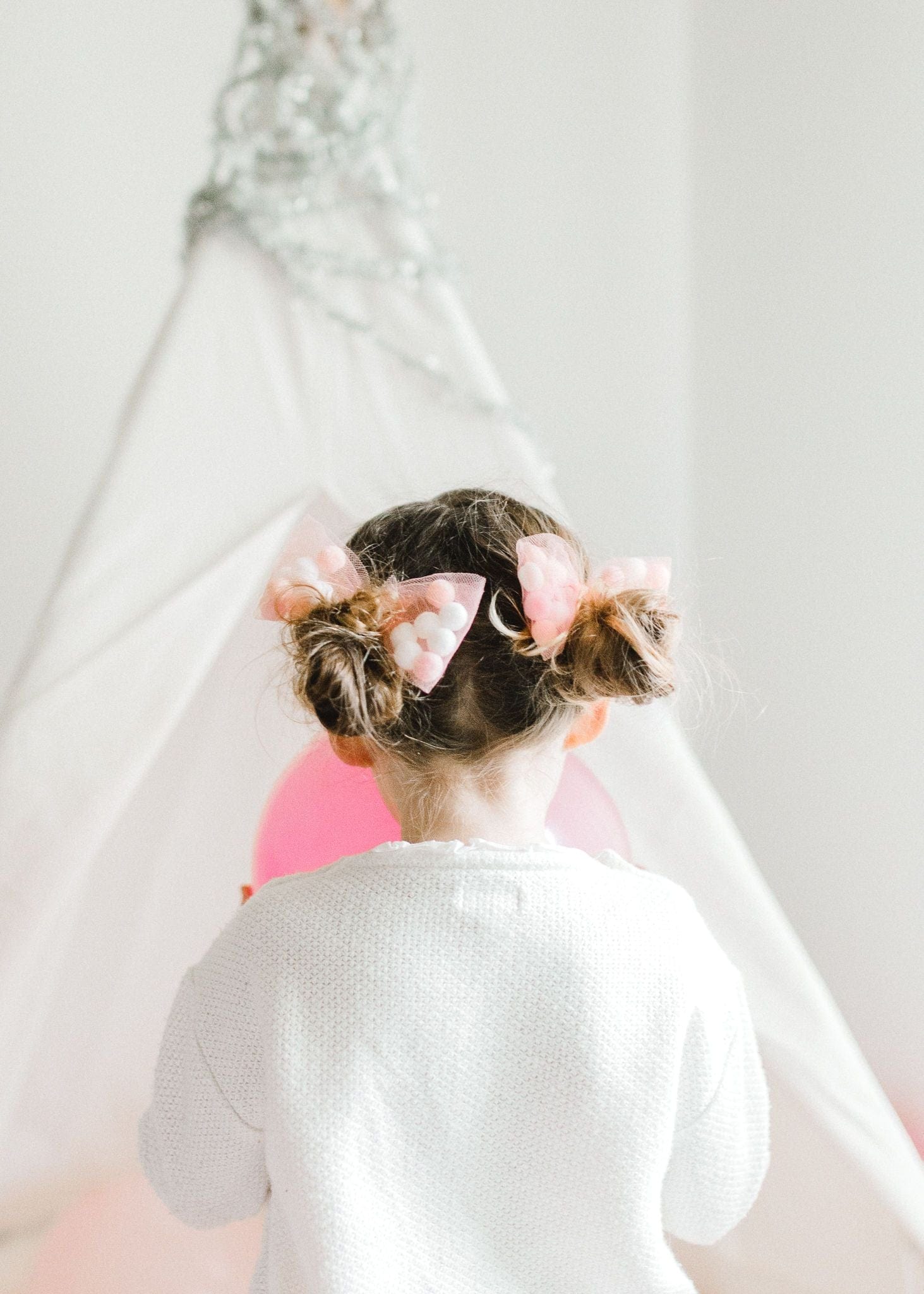 pom pom hair tie bow for children, tutu joli light pink pom pom bow, pom pom tutu rose pink, dusty pink pom pom hair bow, pom pom bow ponytail holder in rose pink, pom pom hair accessories, white and pink pom pom balls tulle bow, pompoms, rose pink hair bow, vintage style hair ties, pigtail holders in white pink with pom pom balls. designer hair ties for girls. tutu joli hair accessories, tulle bow pigtail holders for kids hair, soft hair ties, durable hair ties, strong hair ties